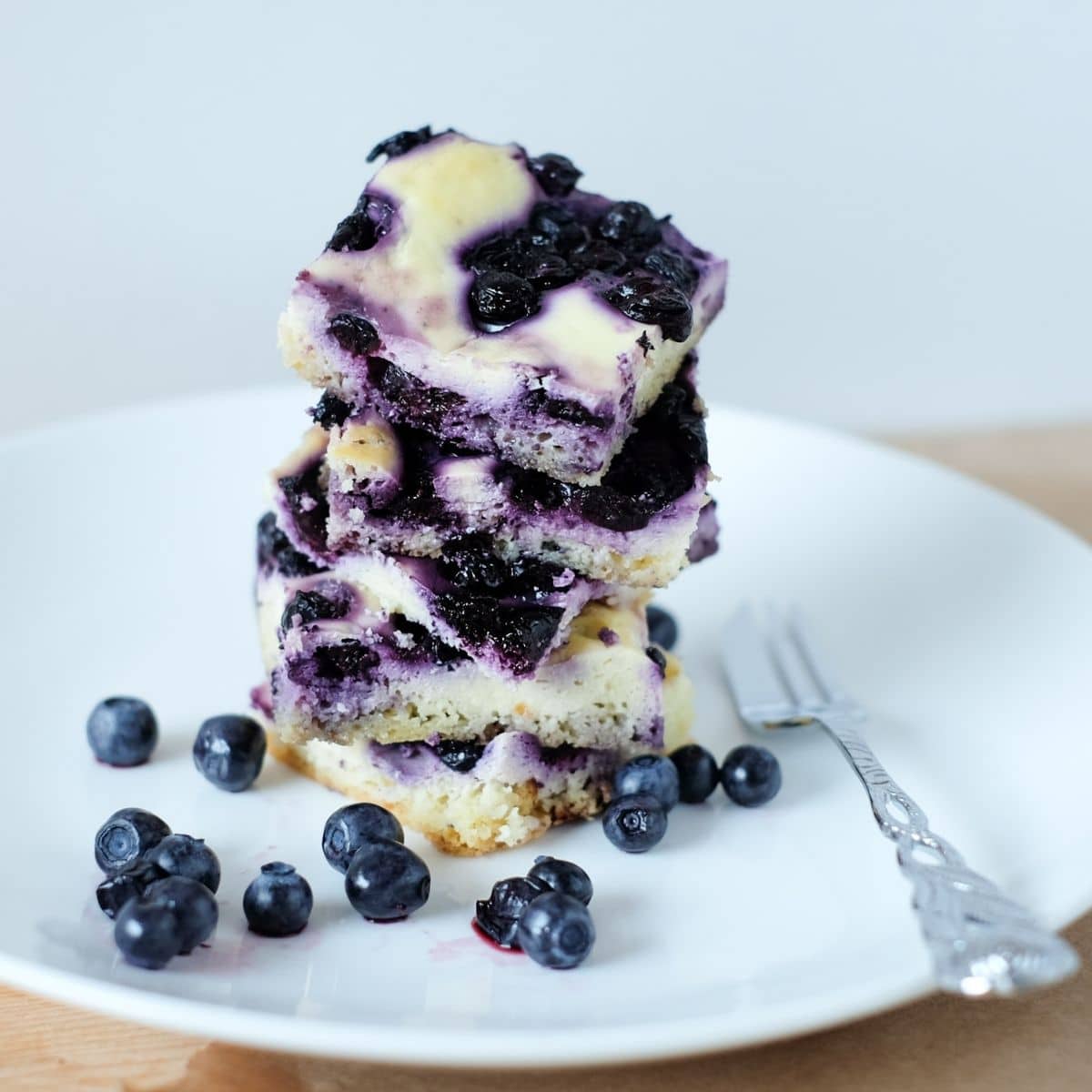 The recipe for delicious low-carb keto blueberry cheesecake bars is ridiculously simple to make, more so if you can get hold of fresh berries.