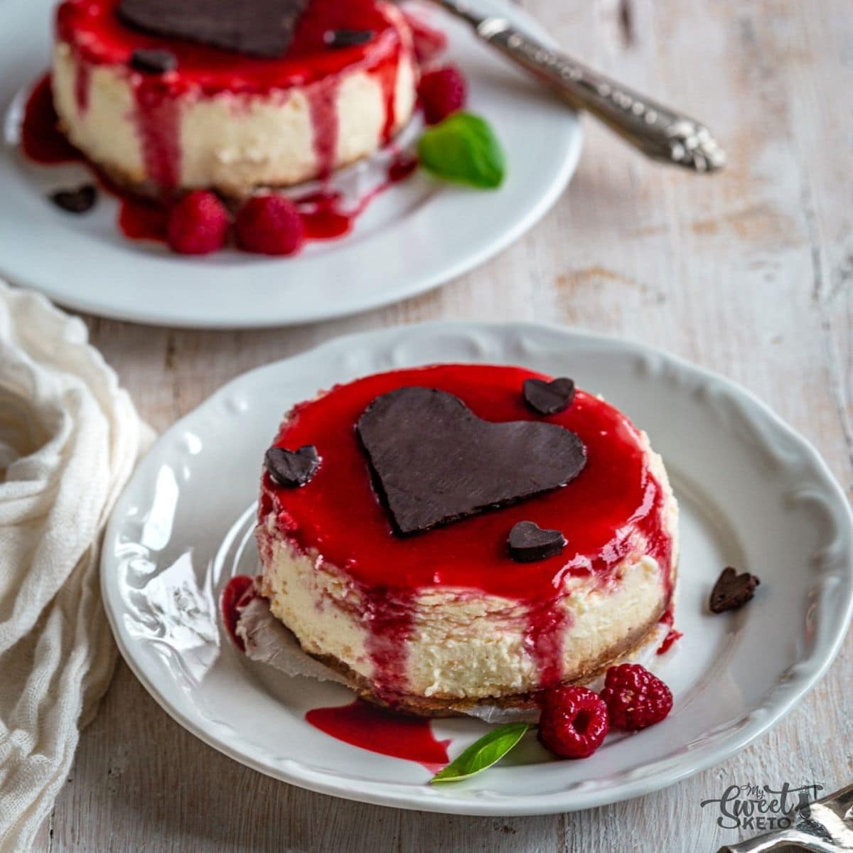 A lovely Keto Valentine's cheesecake for two with chocolate hearts, and a sexy raspberry coulis.