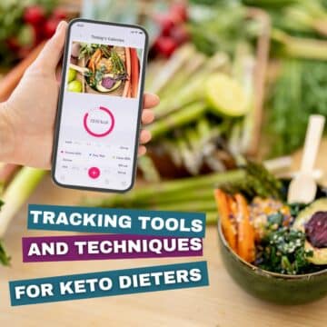 Hand holding a phone with a keto tracking app open next to a colorful low-carb meal with vegetables and salmon.