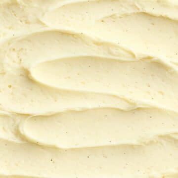 Smooth vanilla keto ice cream close-up with visible bean flecks—highlighting creamy texture.